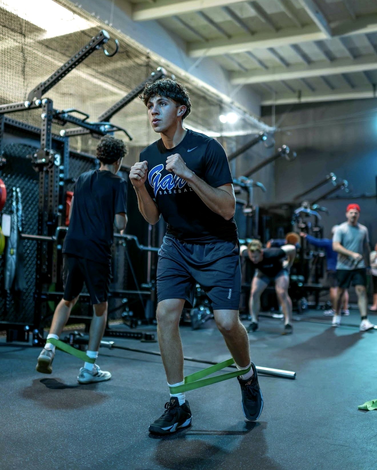 A young athlete works through a resistance-band drill in the weight room at Futures Training Center.