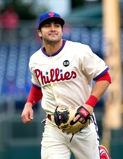 Chase d'Arnaud jogs on the field in a Philadelphia Phillies uniform.