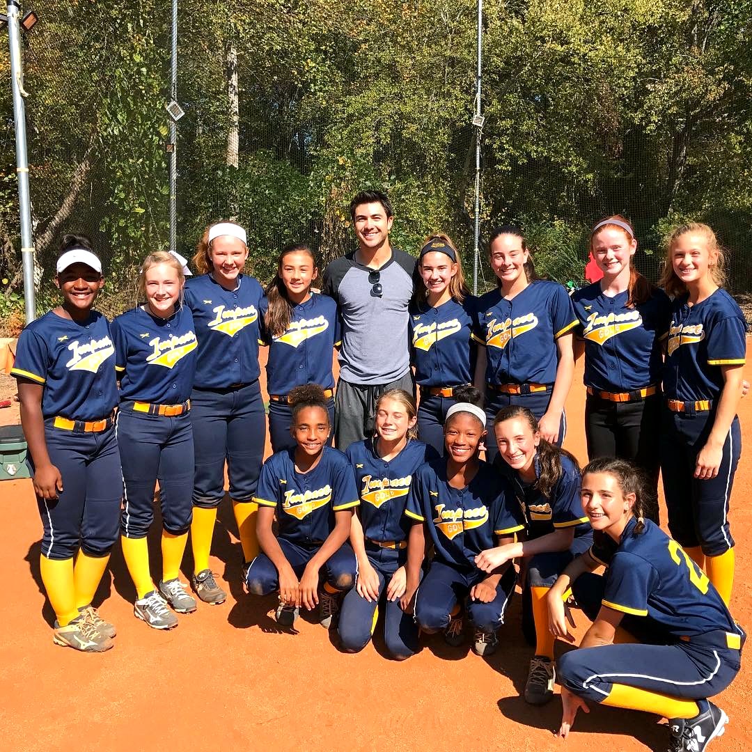 Chase d'Arnaud with an Impact Gold youth softball team on the field.