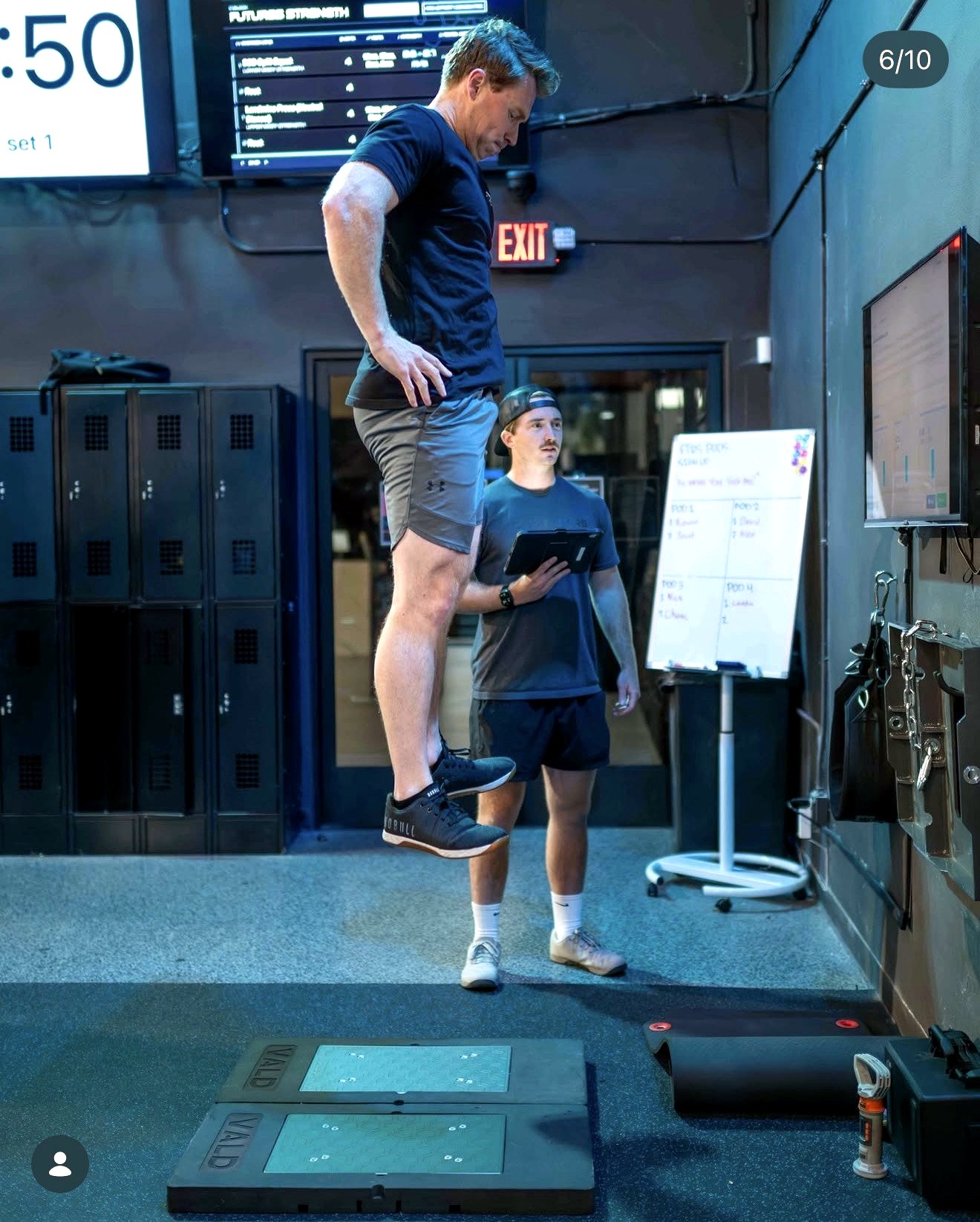 An athlete jumps on force plates while a coach records the result at Futures Training Center.