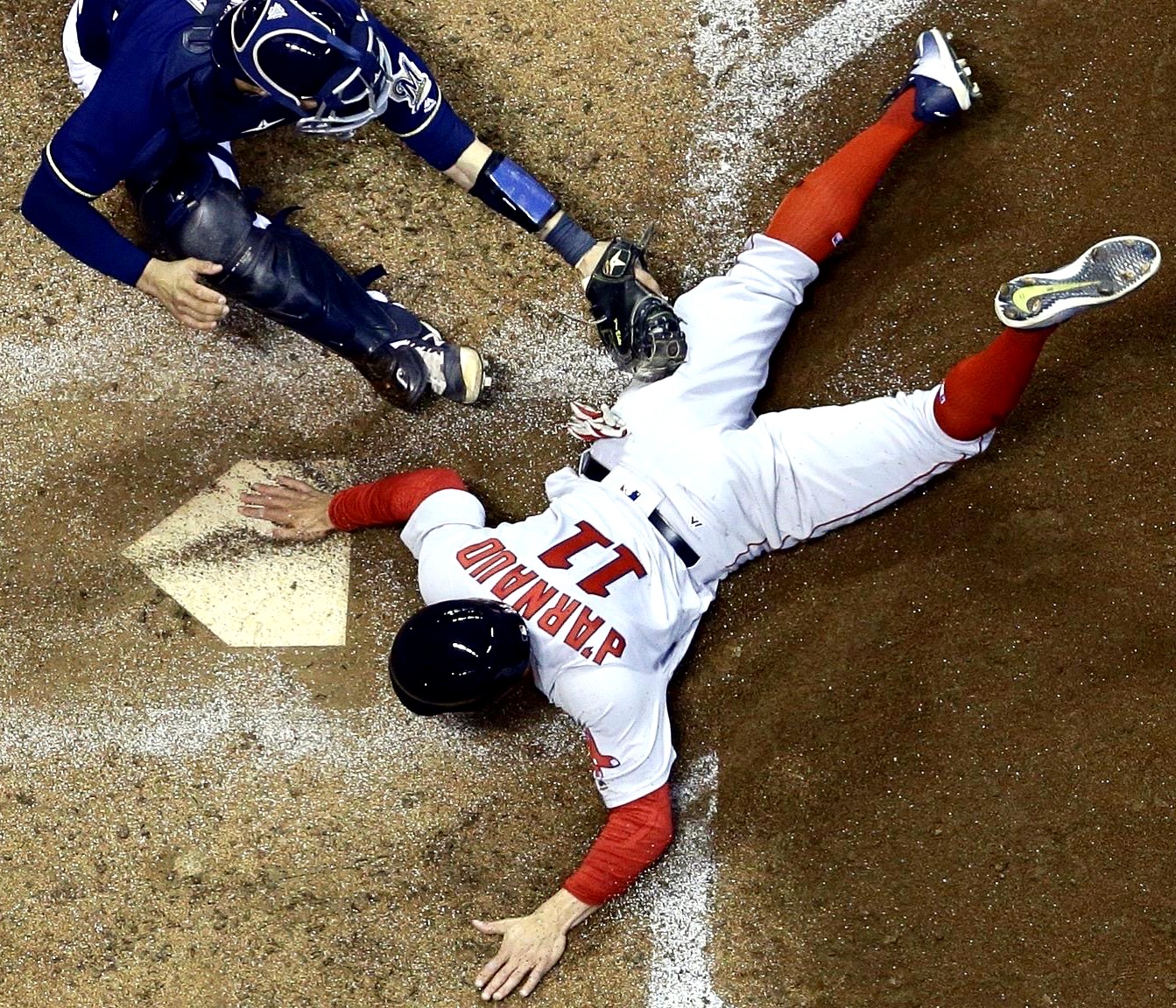 Chase d'Arnaud dives headfirst into home plate for the Boston Red Sox.