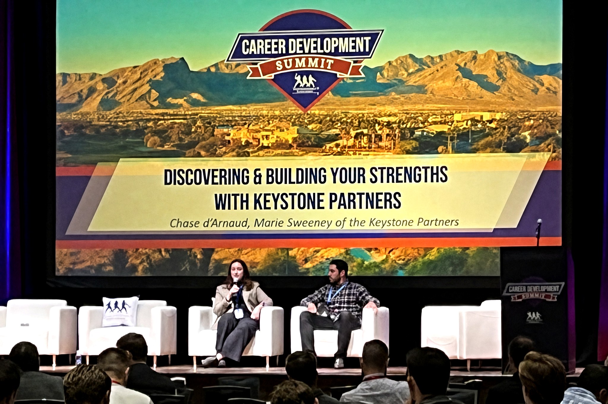 Chase d'Arnaud seated on a Career Development Summit panel, with Keystone Partners on screen.