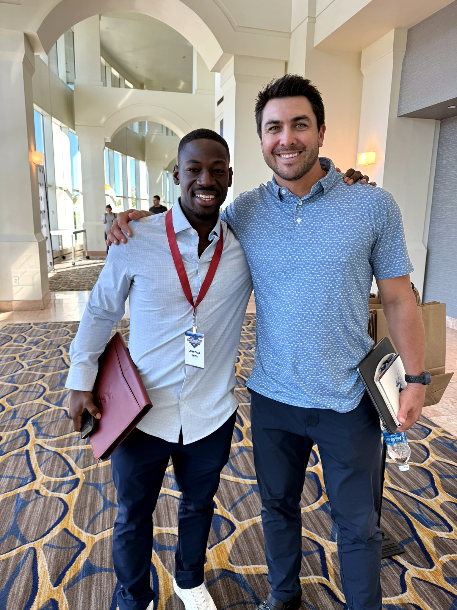 Chase d'Arnaud talks with a fellow player in a hallway at an MLBPA Career Summit.