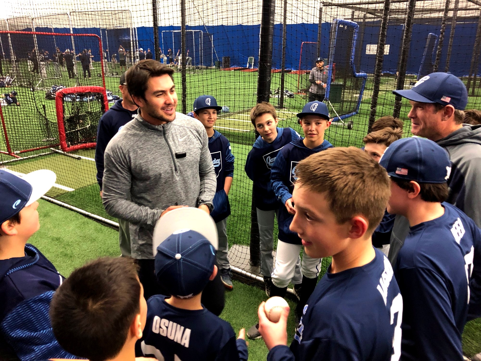 Chase d'Arnaud speaks with young baseball players during an indoor clinic.