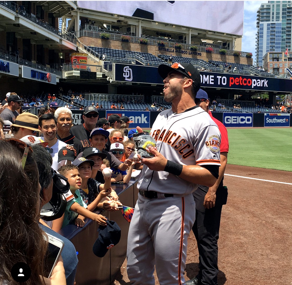 Chase d'Arnaud greets young fans at Petco Park in a San Francisco Giants uniform.
