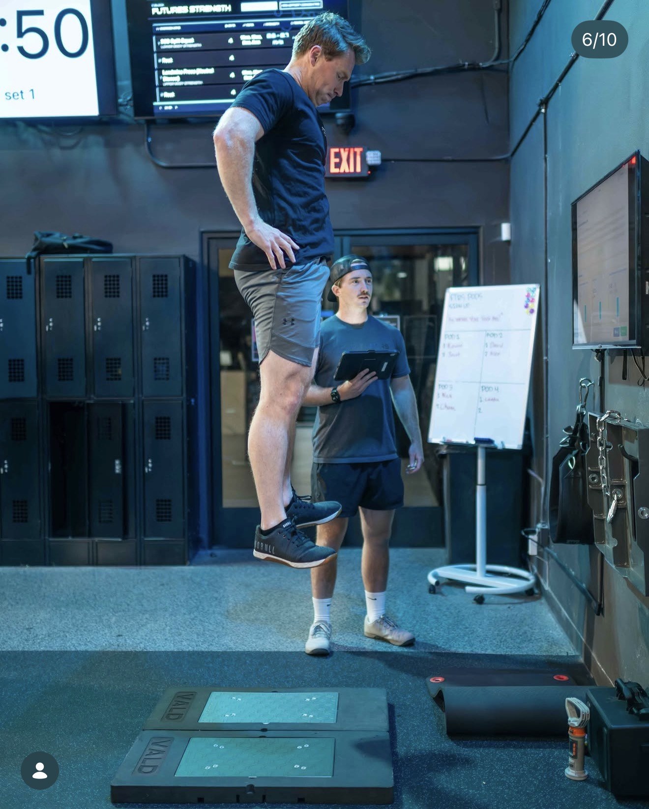 An athlete jumps on force plates while a coach records the result at Futures Training Center.