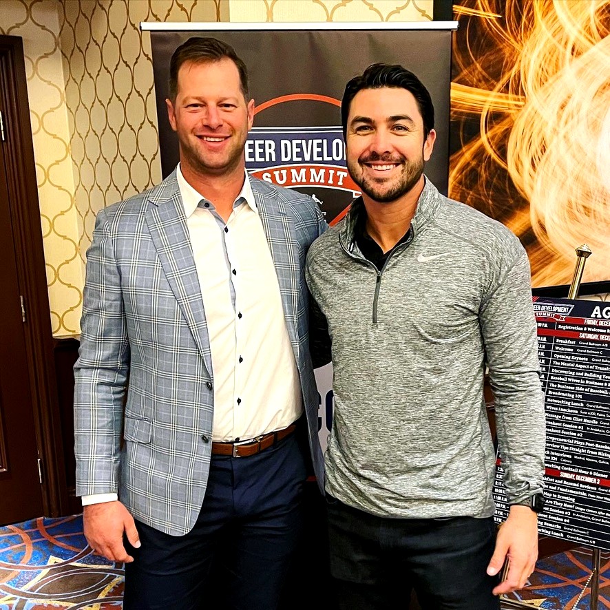 Chase d'Arnaud with another athlete in front of Career Development Summit signage.